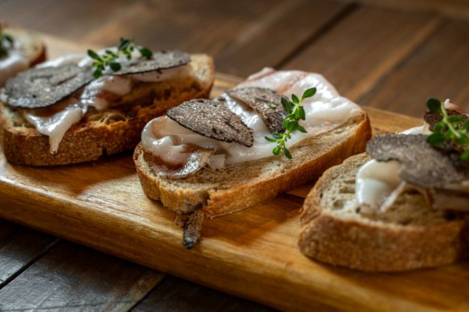 Bruschetta with lard, truffle, and fresh thyme on rustic bread