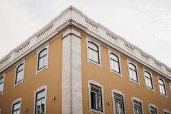 Corner of building against cloudy sky
