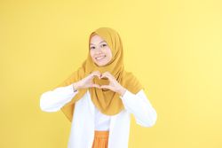 Young Asian Indonesian Woman with Casual Hijab Fashion Making Heart Shape with Her Hand