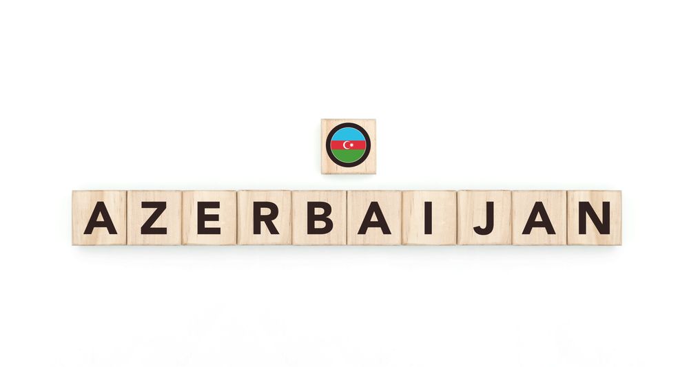 Wooden blocks bearing the name and flag of Azerbaijan. Azerbaijani and Asian Culture, national identity, travel, and geography in a copy space design.