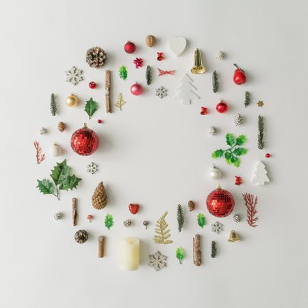 Christmas wreath made of various winter and holiday objects on light paper