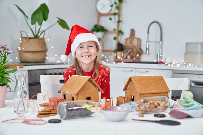 Cheerful girl near gingerbread houses