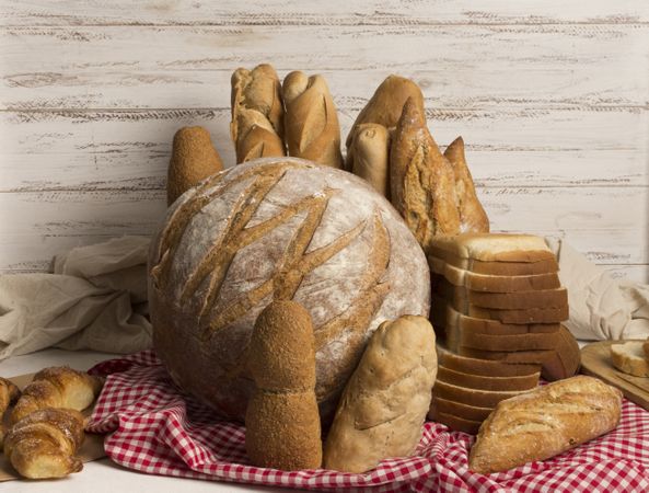 Assortment of bread loaves on a red tablecloth