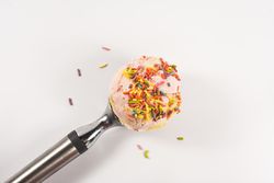Pink ice cream scoop with sprinkles