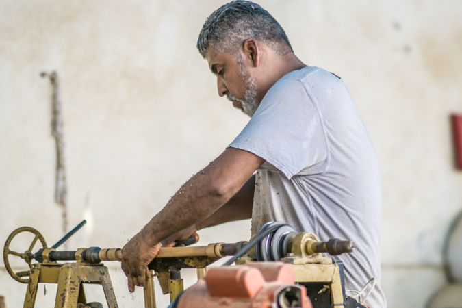 Man using woodworking machine at workplace