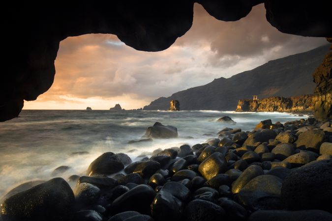 Amazing stone shore and pink sky with clouds