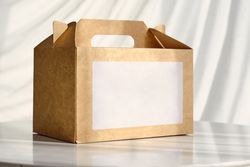 Cardboard box for delivery service on table