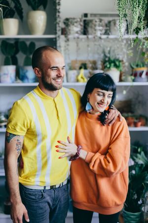 Man and woman hugging in the flower shop.