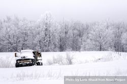 An old truck under a fresh layer of snow in a field bEQ8Nb