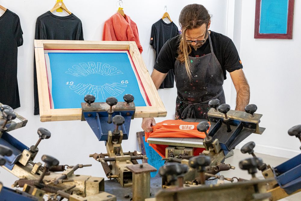Artist printing screen in workshop