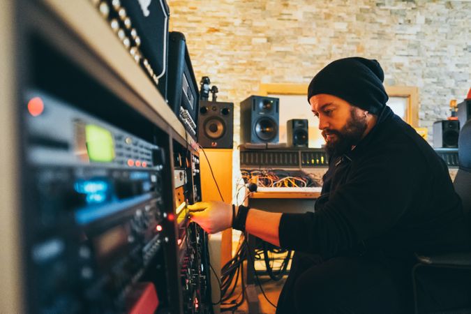 Man adjusting sound control in a studio