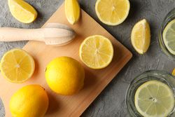 Composition with lemonade and lemons on gray background