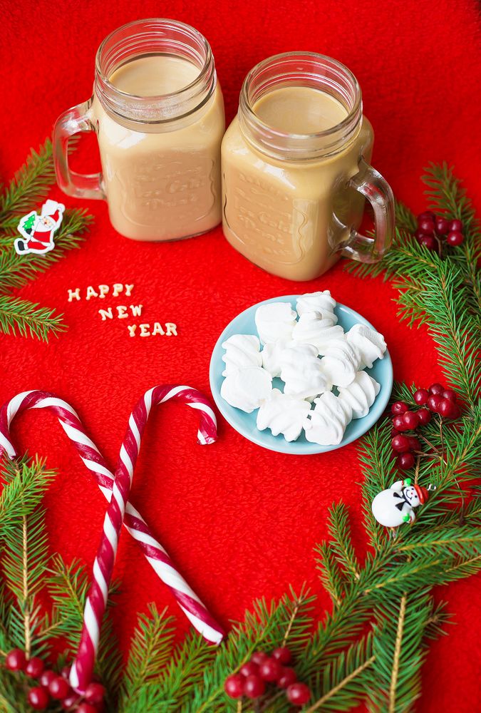 Christmas tree, candy, coffee marshmellou on a red background. The inscription Happy New Year