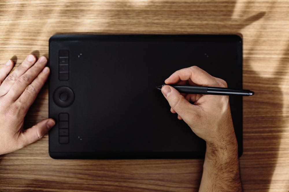Person drawing on tablet