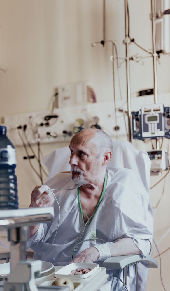 Older man admitted to a hospital room.