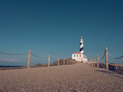 Walkway leading to lighthouse in sunny day