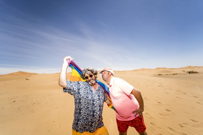 Excited gay couple in desert