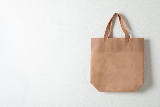 Tote cotton bag on neutral background, space for text