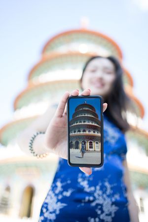 Woman in dress standing next to Wuji Tianyuan Temple