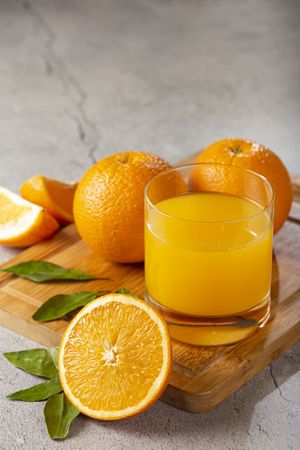 Glass with orange juice on the table.