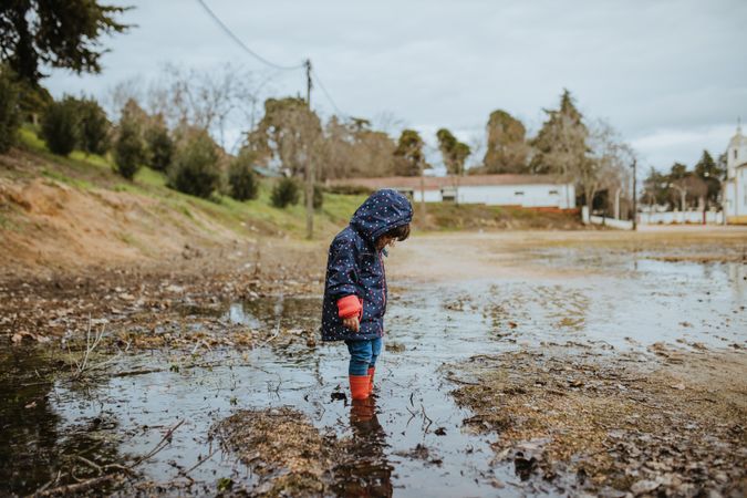 Child in a muddy puddle
