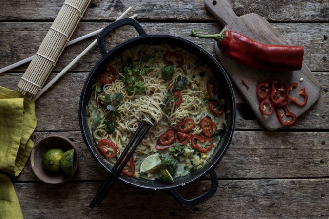 Green curry noodles in pot on table