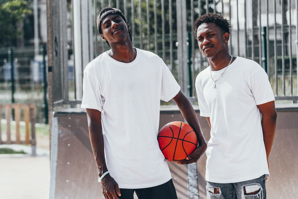 Black sportsmen with ball looking at camera