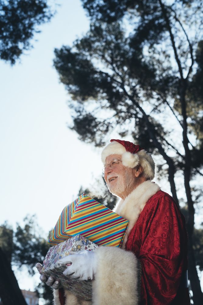 Santa Claus with presents by old van