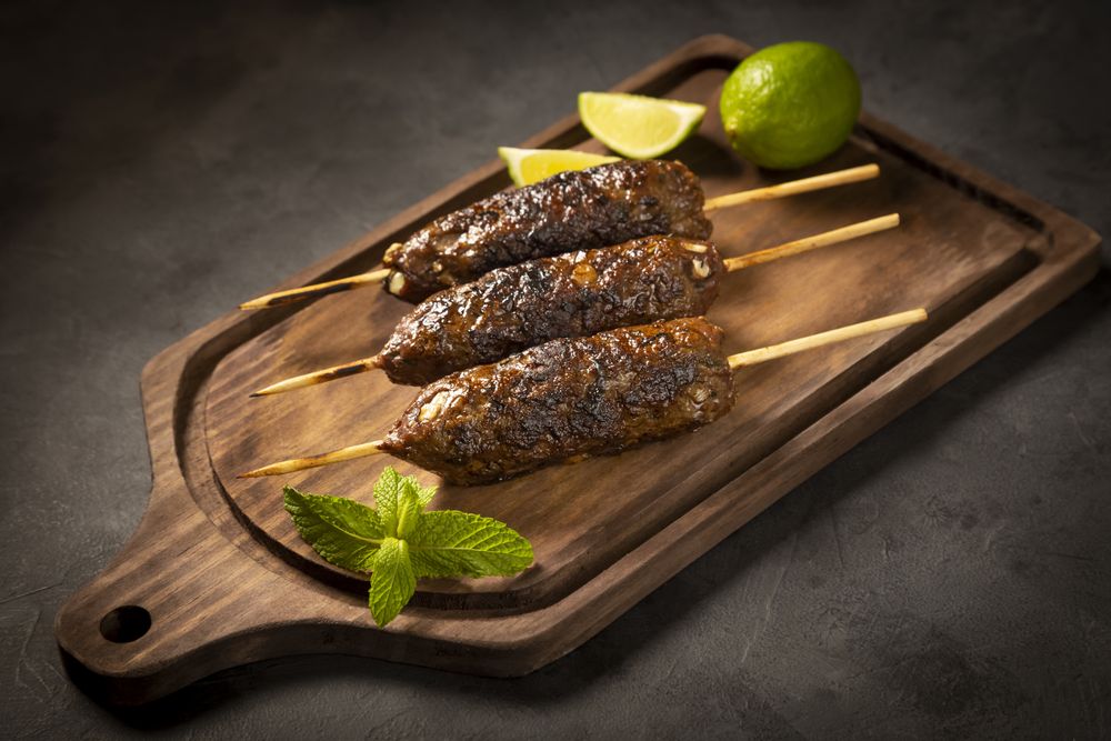 Beef kafta on the wooden board. Kafta, Traditional Arabic cuisine.