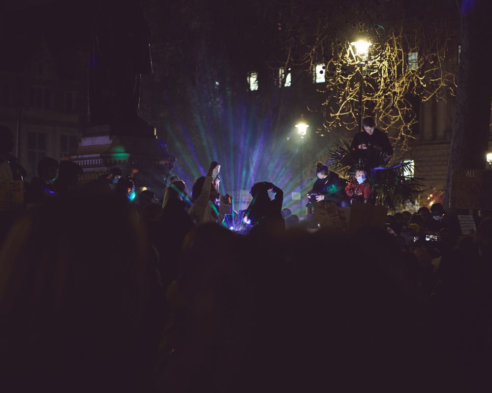 London, England, United Kingdom - March 16, 2021: Protesters against laser colored lights