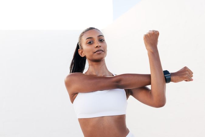 Female stretching arms before or after workout