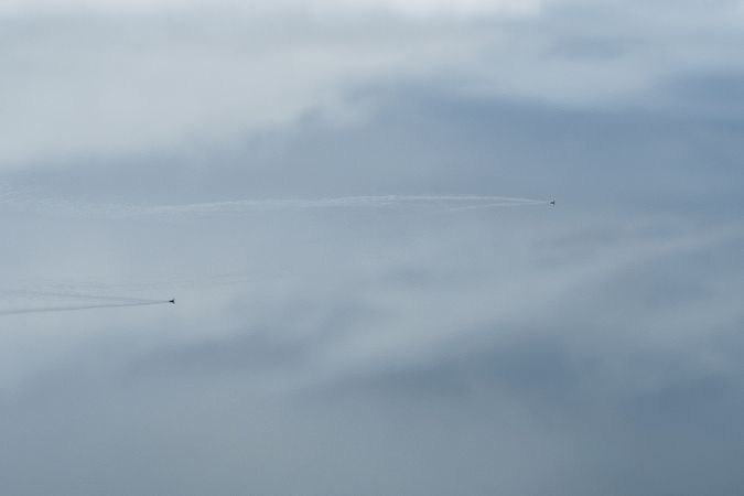 Small speedy aircraft flying in cloudy sky