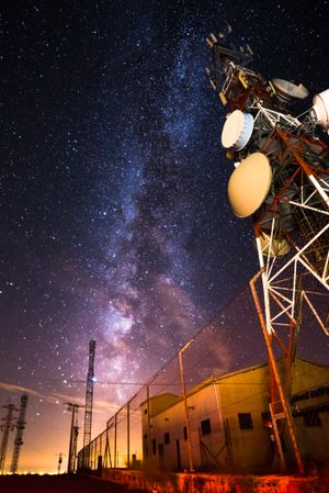 Amazing view of transmission towers against Milky Way in night sky