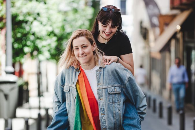 Happy lesbian couple having fun on street
