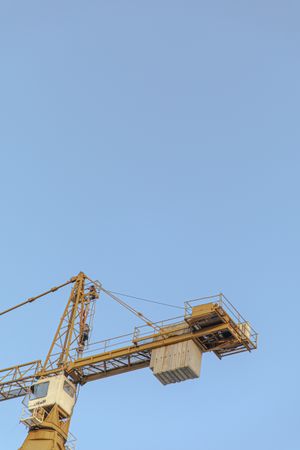 Yellow crane under blue sky