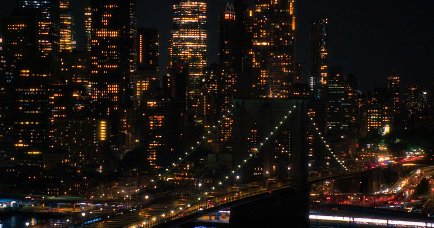 Aerial Top Down Night Scenery with Brooklyn Bridge with Car Traffic Moving in Both Directions on the Road. Helicopter Bird's-Eye View of a Popular American Travel and Business Destination