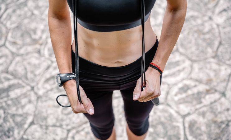 Woman posing with skipping rope in a park