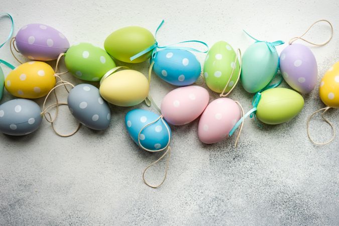 Easter festive card concept with pastel egg decorations on grey table