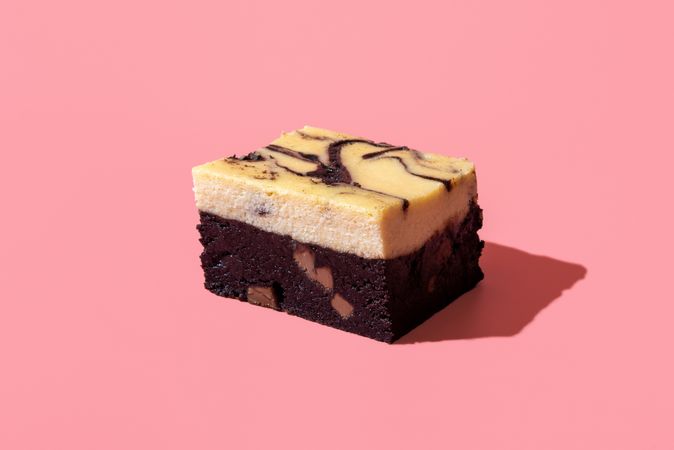 Cheesecake brownie minimalist on a pink background