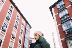 Contemporary woman on street against buildings