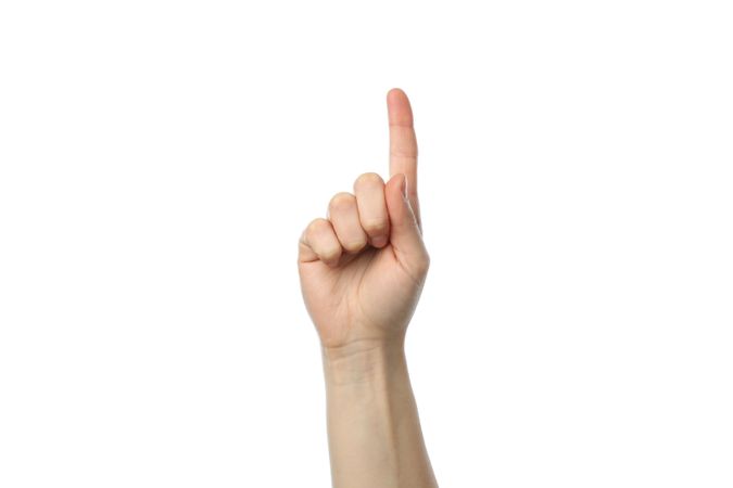 Female hand points, isolated on plain background