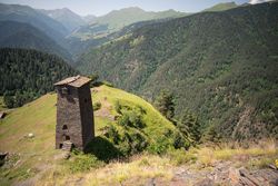 Tall old defensive building in majestic mountains in summer sunny day