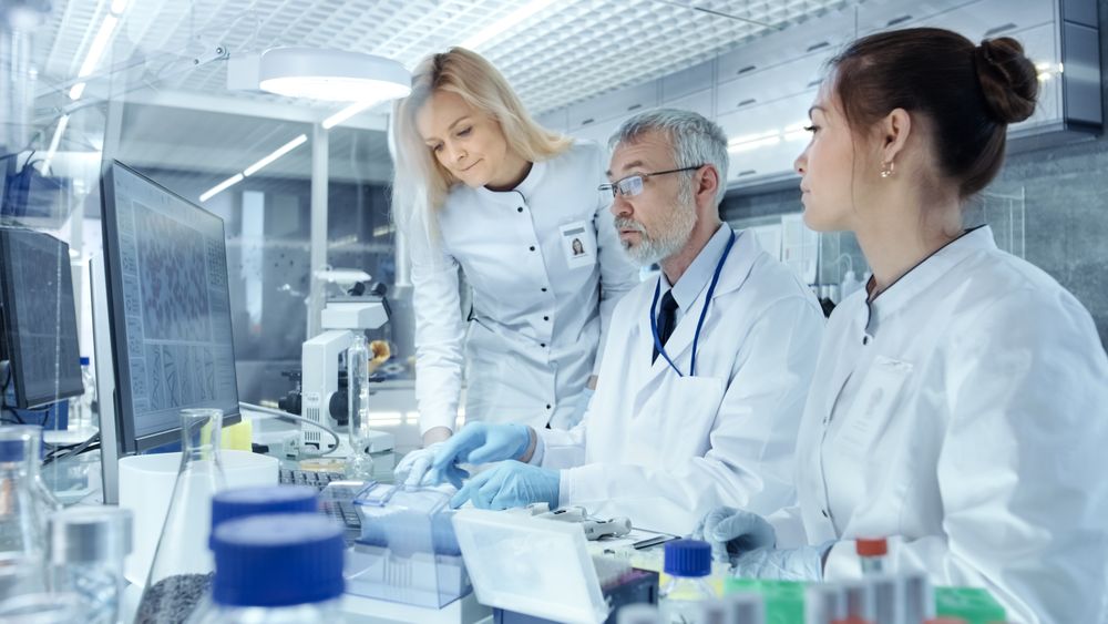 Team of Research Scientists Working With Personal Computer, Analysing Test Trial New Generation Drug Data.