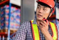 Man in PPE gear talking on radio