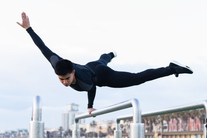 Athlete doing exercise on parallel bars