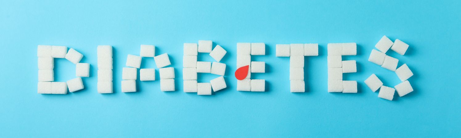 Diabetes made of sugar cubes on blue background