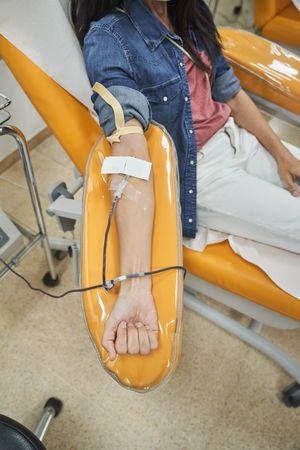 Unrecognizable woman giving blood in hospital