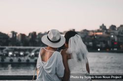 Bride and woman taking selfie near body of water 5Qdod0