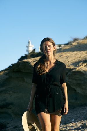 Calm woman enjoying sun on beach