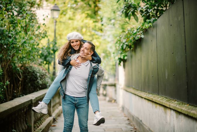 Happy couple having fun together at overgrown city street